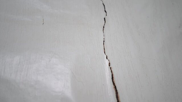 Panning view of the termites damage on the house wall