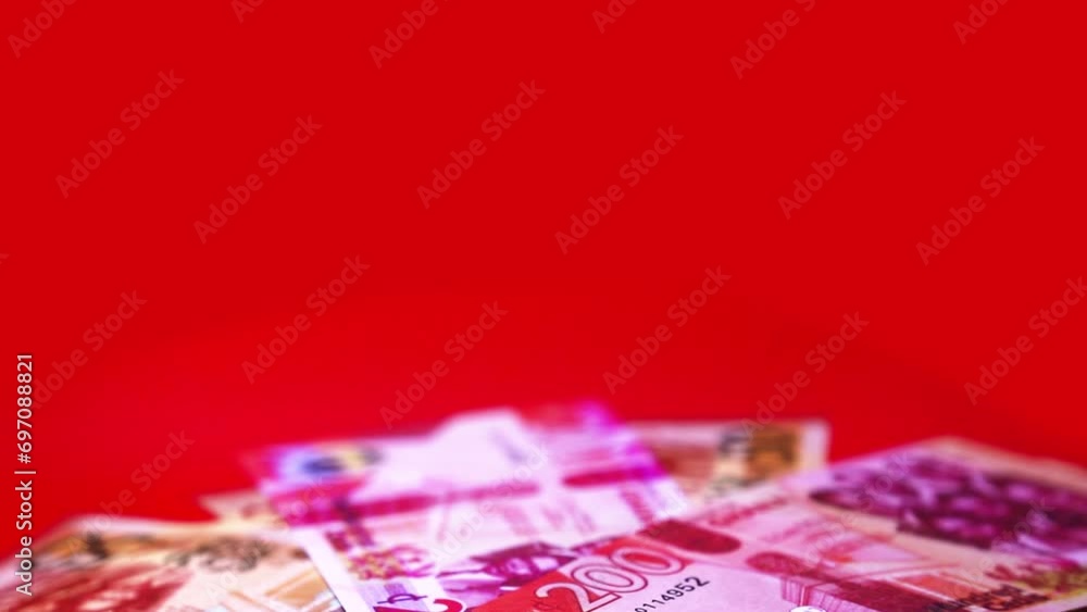 Poster camera panning 360 degrees around spread ghanaian cedi notes. camera moving around scattered cedis n