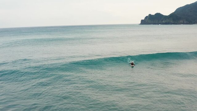 Surfer catching a wave alone