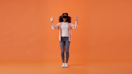 African American lady plays game in virtual reality glasses