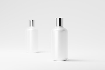 A set of glossy plastic cosmetic bottles with a silver cap