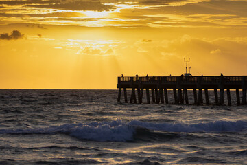 Majestic sunrise rays over Lake Worth Pier, ideal for vibrant travel brochures and inspirational wall art.