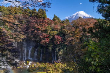 See Mount Fuji thru Shiraito Falls with rainbow in autumn, Shizuoka, Japan - 697111638