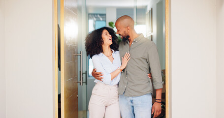 Home, hug and couple with doorway, funny and marriage with relationship, bonding and romance. Apartment, people and man with woman, embrace or happiness with humor, smile and laughing with date
