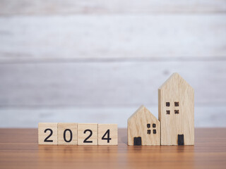 Wooden block with 2024 and miniature house. The concept of Property investment, House mortgage,...