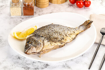 Baked Dorado fish served lemon