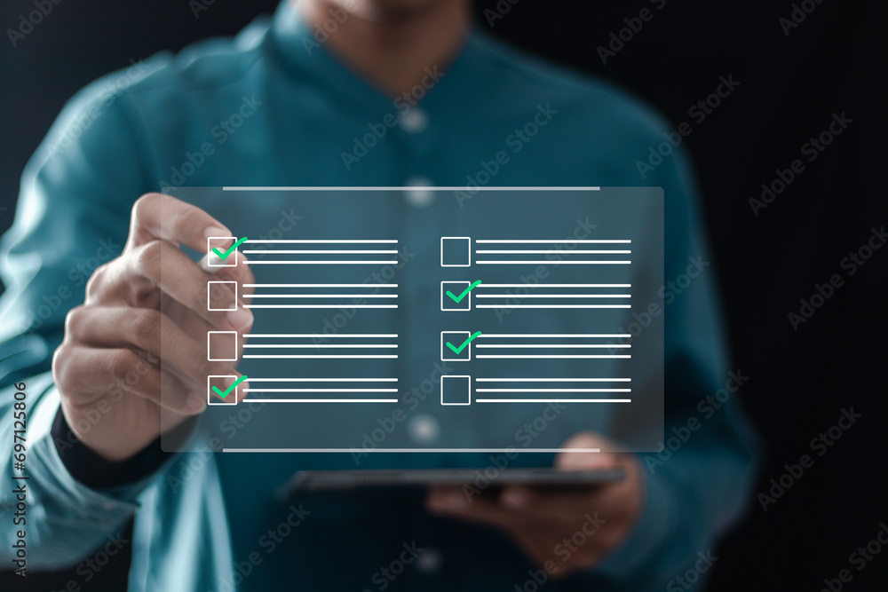 Wall mural businessman filling survey form online on questionnaire with checkboxes for answer questions of test