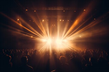 Concert with silhouettes of people clapping in front of a big stage with spotlights View of the crowd at a concert
