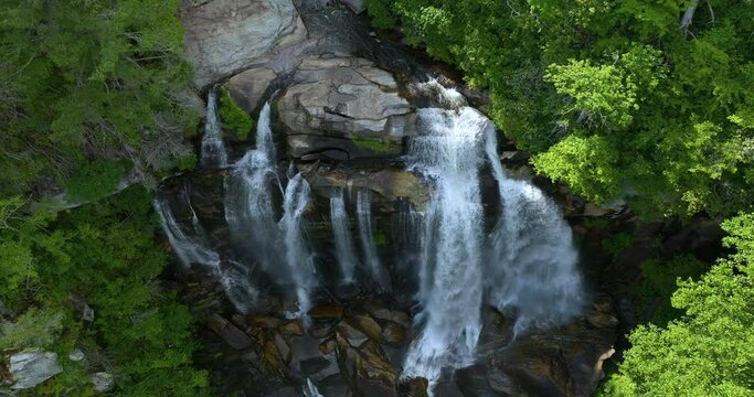 Amazing summer landscape with forest river waters falling down in big waterfall with clear water between rocky boulders in Nantahala National Forest. Whitewater Falls, North Carolina, USA