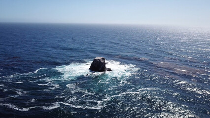 Waves crashing on a rock on the pacific ocean in California near big sur northern CA