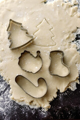 Cutting Christmas shapes into cookie dough