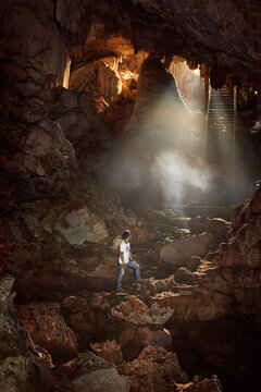 A man standing inside the cave