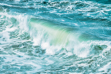 Fototapeta premium Wave splashing close-up. Crystal clear sea water, in the ocean in San Francisco Bay, blue water, pastel colors.