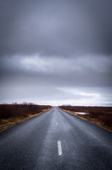 Empty road leading to the snowy mountains at snaefelness peninsula in Iceland