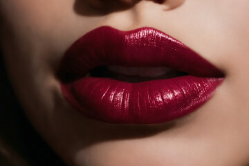 Close-up of beautiful lips with bordeaux lipstick