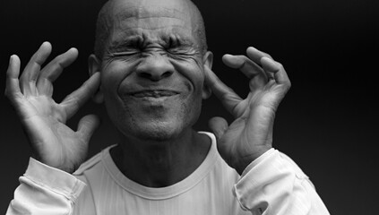 deafness suffering from hearing loss on grey black background with people stock image stock photo	