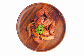 Cooked grilled chicken wings marinated with seasonings Placed on an old wooden tray on a white background