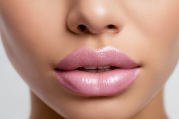 Close-up of beautiful lips with light pink lipstick