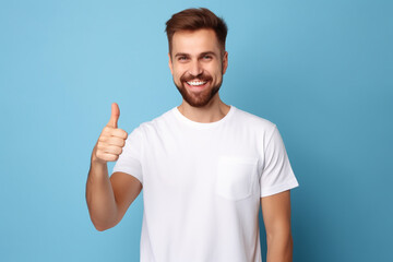 Naklejka premium Portrait of cheerful man smiling and showing thumb up over blue background