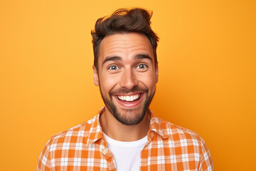 handsome bearded posing against wearing check orange shirt on orange background