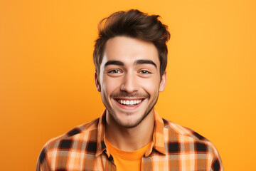Fototapeta premium handsome bearded posing against wearing check orange shirt on orange background