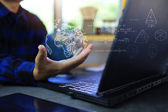 Math and physics equation concept with student hand holding globe with quotations function of geometric and law of motion in front of laptop screen on desktop
