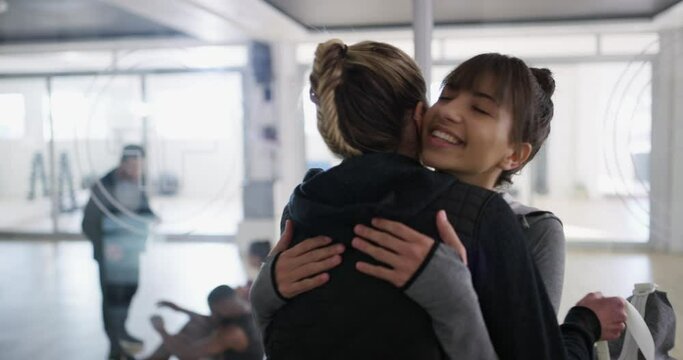 Happy people, start or hug in gym for fitness workout, exercise or healthy wellness together. Women, teamwork and sports athletes ready for a training class with friends, love or smile for support