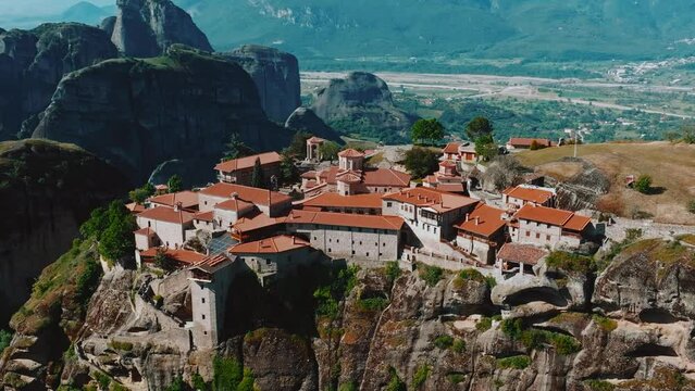 Flying over Meteora Monasteries, Greece. Landscape scenery with green hills, rocks, and old Monasteries on it.