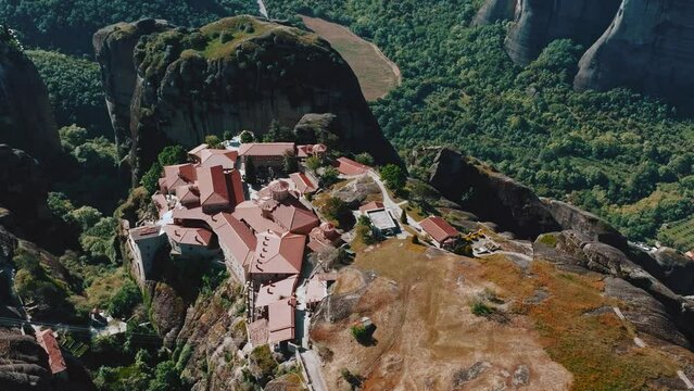 Flying over Meteora Monasteries, Greece. Landscape scenery with green hills, rocks, and old Monasteries on it.