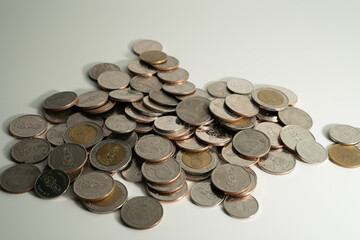 Coins stacked on each other, isolated on a white background.