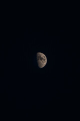 Moon in its full glory in a dark sky. Holes and depressions on an orbiting body in outer space. The white-grey moon