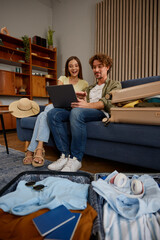 Happy young couple rejoicing finding travel tour online planning vacation
