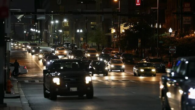 Baltimore Evening City Street. Cars are Turning Left, Daily Traffic and Street Lights in Background. Maryland State