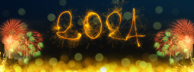 Happy New Year 2024.  Sparkling text  2024 on dark blue background with fireworks and golden bokeh....