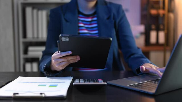 Businesswoman hand using smart phone laptop and tablet with social network diagram on desk as concept.