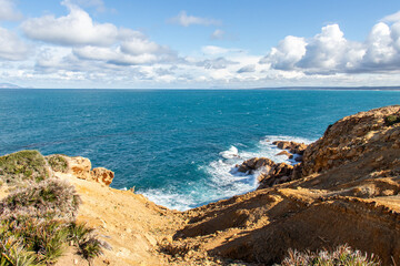 Fototapeta na wymiar Port aux Princes, Tunisia, Cliffs and Rocks, Mediterranean Sea landscape with beautiful blue sky. Heavenly Escape. Takelsa