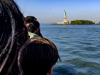 Beautiful and spectacular photograph of people watching from a boat the famous and fabulous Statue...