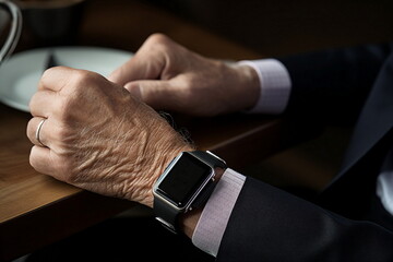 senior man hand hold smart watch