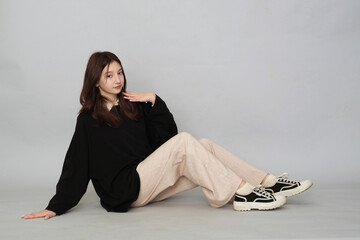 Young girl posing in a versatile black hoodie, a staple for any casual or streetwear-inspired teen...