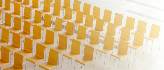 Rows of chairs meeting background on sunlight. View from above.