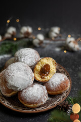 traditional Ukrainian holiday pastries Pampushki. Donuts with powdered sugar and condensed milk filling. Festive table for Christmas. Christmas treat, dessert. Ukrainian traditional cuisine. Dumplings