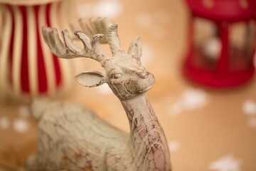 Christmas holiday composition. Wooden deer figurine in front plan.
