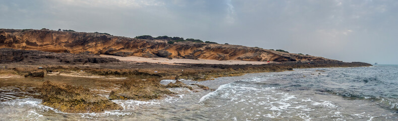 Fototapeta na wymiar Harmony of Land and Sea: Rimel's Mountainous Landscape Meets Tranquil Beach in Bizerte, Tunisia