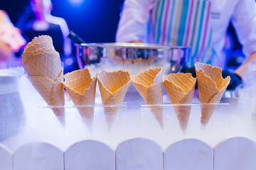 close up waffle cones on stand and smoke of nitrogen. ice cream - obrazy, fototapety, plakaty