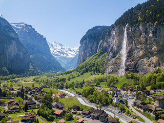 Aerial image of the beautiful village Lauterbrunnen with Staubbach waterfall and snow mountain Jungfrau at the background