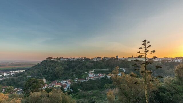 Panorama showing sunset over the Castle of Almourol on hill in Santarem aerial timelapse. A medieval castle atop the islet of Almourol in the middle of the Tagus River and houses. Portugal