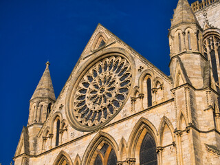 Fototapeta na wymiar York, UK - Nov 24 2023: The circular Rose Window over the South Door in the South Transept of York Minster in northern England, UK. Taken on a sunny day with a blue sky.