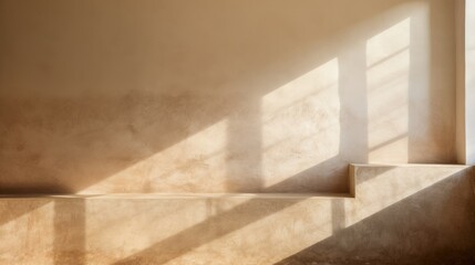 Morning sunlight casting geometric shadows in a minimalist empty interior with a warm, sandy tone.
