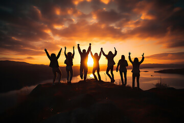 hikers celebrating success on top of a hill in the sunset