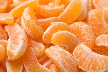 Segments of tasty tangerines as background, closeup